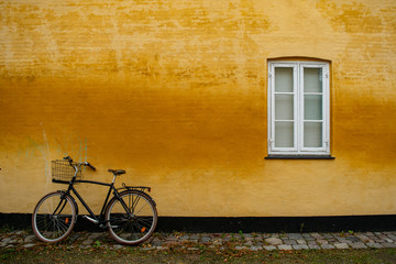 Fototapeta na wymiar Parked bike in a yellow wall