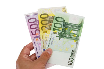 100, 200 and 500 euros in a hand isolated on white background....