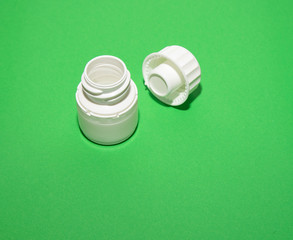 Step 3. A white jar of pills is open with a lid