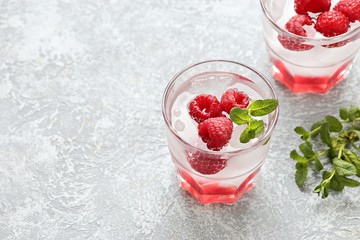 Raspberry infused water, coctail or lemonade. Summer iced cold drink with raspberry, lemon and mint. Selective focus