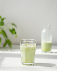 Green matcha latte with almond milk. Summer refreshing beverage drink. Selective focus