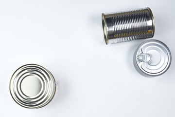 tin cans of different sizes on a white background. copyspace.