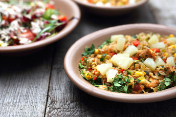 Rice curry with vegetables. Appetizing dish on a wooden background.
