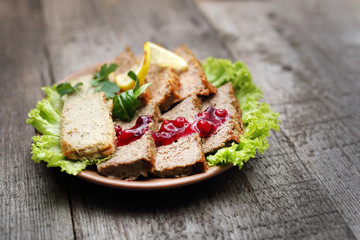 Pate with cranberry.
Appetizing dish on a wooden table.