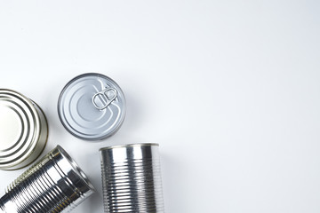 tin cans of different sizes on a white background. copyspace.