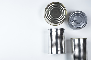 tin cans of different sizes on a white background. copyspace.