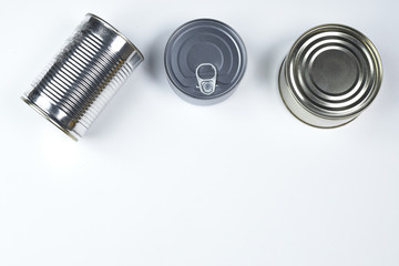 tin cans of different sizes on a white background. copyspace.