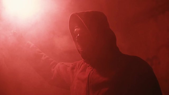 masked ultras ignite fire in an abandoned building at night