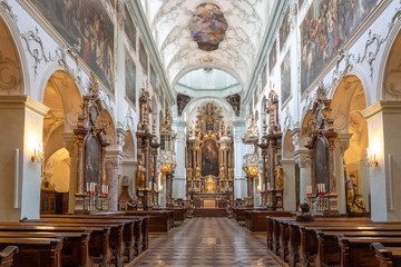 Fototapeta na wymiar Feb 4, 2020 - Salzburg, Austria: Nave view of Rococo Ornamentated Abbey church interior inside St Peter Abbey