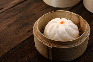 Steamed Bun in steamed dish in a bamboo steamer.