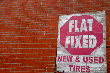 Distressed old fix a flat tire red and white sign