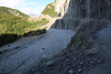 Mountainous road leading to Lahic village in Ismayilli region of Azerbaijan, with car.