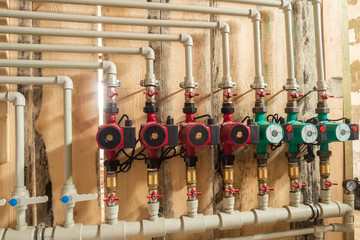 Distribution header of the heating system in the boiler room, with circulation pumps