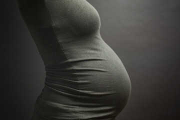 Pregnant Woman With a Belly, Side View, Studio Portrait