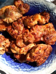 Big piece of slow cooked oven-barbecued pulled pork shoulder on chopping board on plate, view from above, close-up. Close-up of roasted healthy chicken fillets. Top view, horizontal orientation.