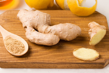 Ginger fresh root on a wooden chopping board.