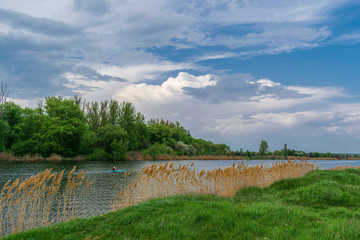 Osnny landscape in the Zhuravlevsky Hydropark of Kharkov with a view of the river and a man in a kayak