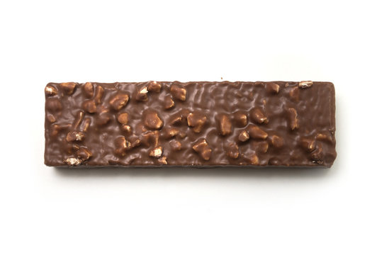Closeup of chocolate bar with nuts on white background on top view