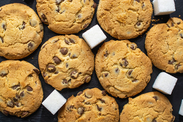 cookies on a black background with pieces of sugar