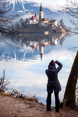 photographer woman taking photos of Bled island