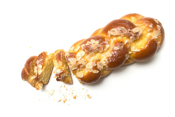 Closeup of braided almonds cake on white background on top view