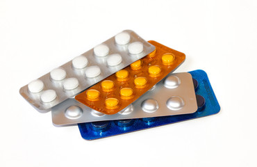 Pills in a blister pack close-up. Painkillers. Protection from coronovarus Covid19. Colored tablet packages. Medicine for the first-aid kit.