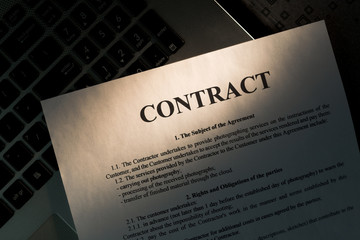 Pen for signing the contract. The pen and contract are on the laptop.