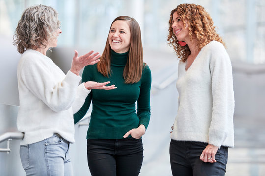 three women interacting at work