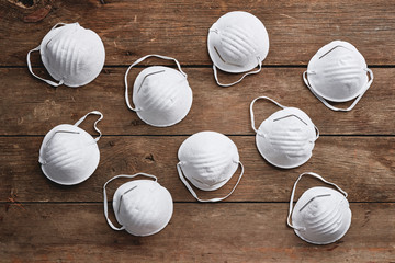 a group of face masks on a wood surface