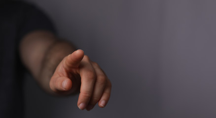 Obraz premium A man hand touching virtual screen, modern background concept , can put your text at the finger, copy space.