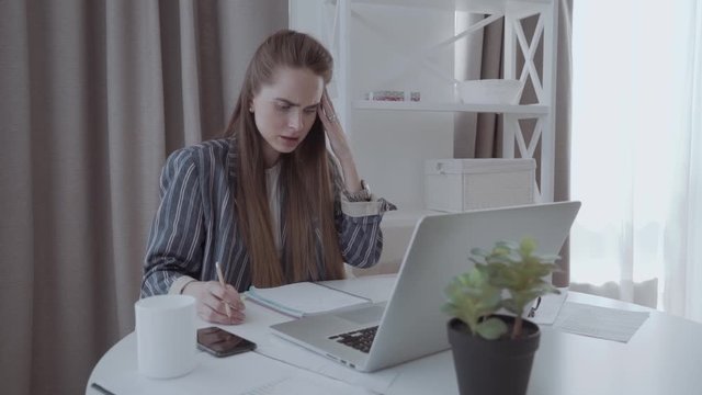 Young businesswoman at modern home office desk with laptop impressed by the bill to pay, at a loss, revealed online affair, negative email, system error