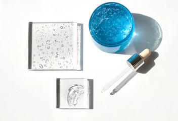 Cosmetic hydrating product or ingredient concept flat lay. Hyaluronic acid gel on the white...