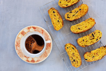 Close up of Italian biscotti and cup of coffee on light grey background.