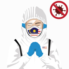 Covid-19 or Coronavirus concept. Malaysian medical staff wearing mask in protective clothing and praying for against Covid-19 virus outbreak in Malaysia. Malaysian man and Malaysia flag. Epidemic