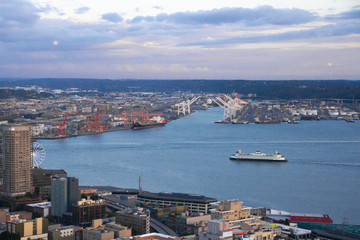 Obraz premium Arial view of Seattle from the Space Needle just before sunset with dark clouds moving in against a blue sky Royalty free stock photo