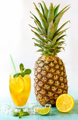 Yellow iced tea with pineapple, lemon