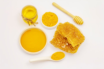 Fototapeta na wymiar Dry turmeric powder, honey and honeycombs isolated on white background