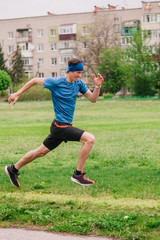 young guy runs morning stadium workout
