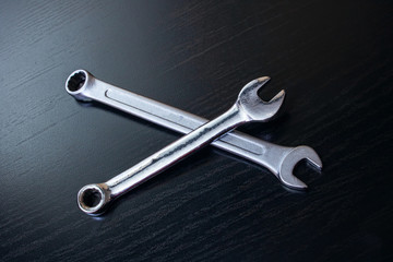 Two wrenches on a wooden table closeup