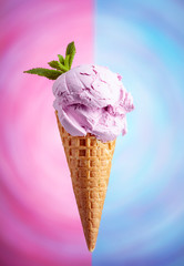 Blueberry ice cream in waffle cone.