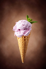 Blueberry ice cream in waffle cone.
