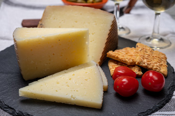 Spanish tapas, manchego cheese made, green olives served with glasses of dry fino sherry wine