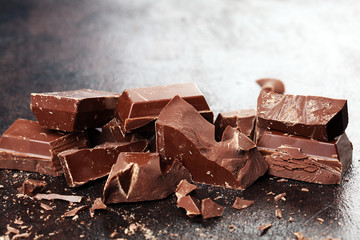 Dark chocolate stack, chips and powder with chocolate bars and block