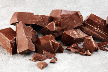 Dark chocolate stack, chips and powder with chocolate bars and block