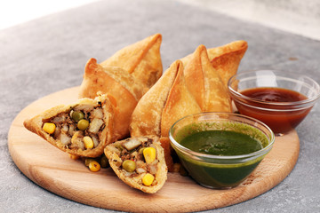 Vegetarian samsa or samosas.Indian special traditional street food fried punjabi samosa or Coxinha,...