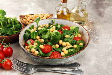 chickpea salad with ingredient and tomatoes and lamb´s lettuce. healthy salad