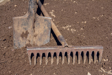 Hand shovel and rake. Garden tools before spring plantings. Hand Tools