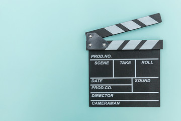 Fototapeta na wymiar Filmmaker profession. Classic director empty film making clapperboard or movie slate isolated on blue background. Video production film cinema industry concept. Flat lay top view copy space mock up