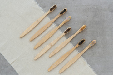 Zero waste Set of wooden bamboo toothbrushes on a concrete background. Flat lay plastic free concept