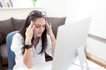 Attractive Business Woman Having Headache While Working on Home Desktop. Stressed And Depressed Young Lady Touching Her Head, Feeling Pain,  Work Failure Concept